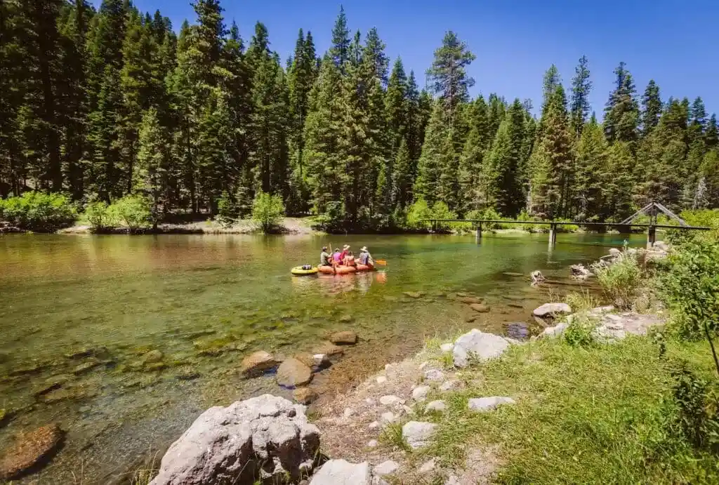 Family rafting down the Truckee River with Truckee River Raft Co on a sunny day